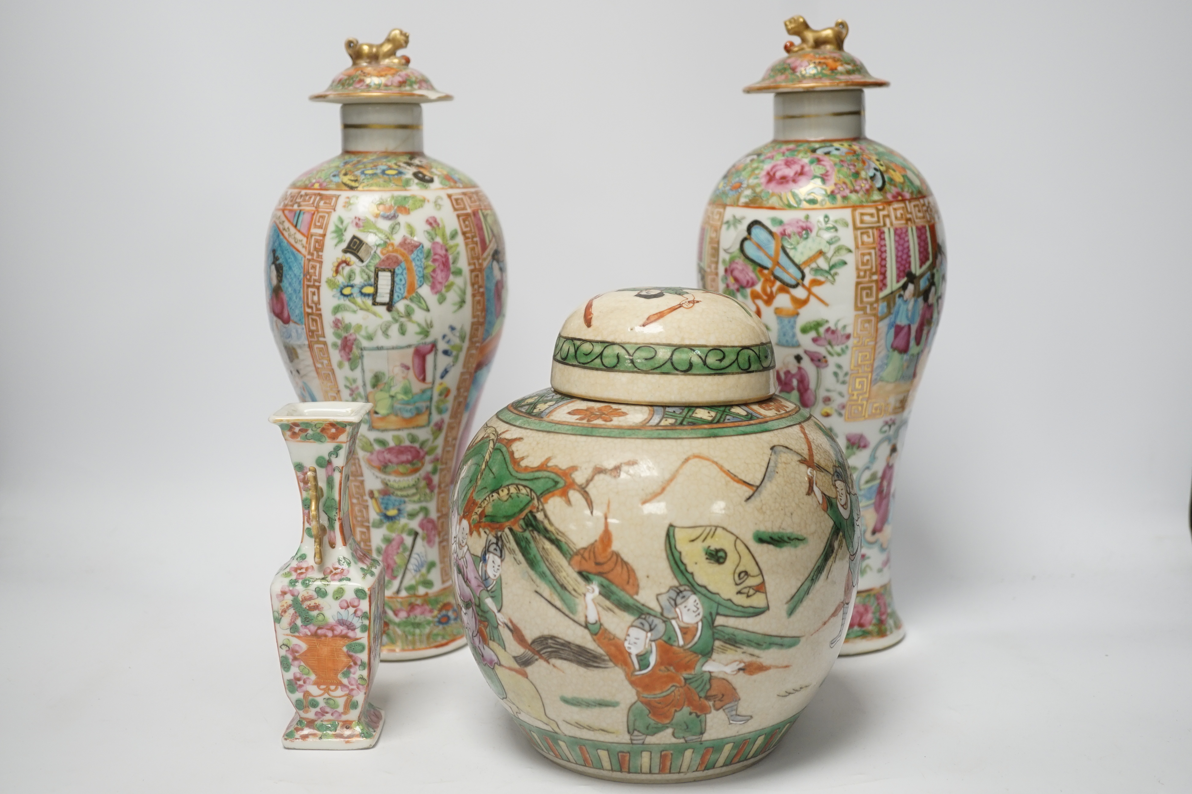 A pair of 19th century Chinese famille rose vases and covers, a similar small vase and a a famille verte crackle glaze jar, tallest 31cm